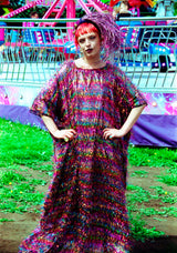 Model wearing the TINSEL Maxi Black and Multicoloured Shimmer kaftan Dress at the funfair